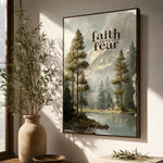 a framed painting of a serene landscape with trees, a lake, and mountains, hanging on a wall.