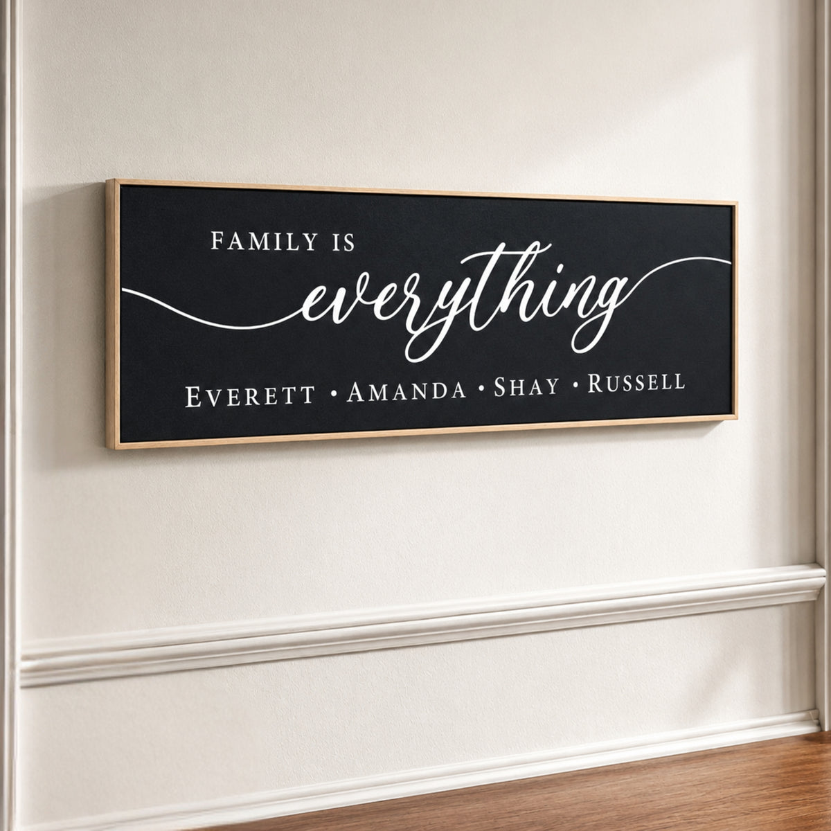 The image is a black and white sign with the text "Family is everything" written on it.