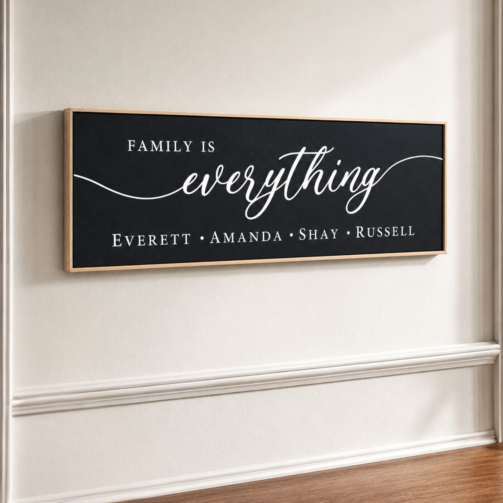 The image is a black and white sign with the text "Family is everything" written on it.
