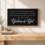 a black framed sign with white text that reads "All my life you have been faithful, all my life you have been so, so good with every breath that I am able oh, I will sing of the Goodness of God" against a wooden background.