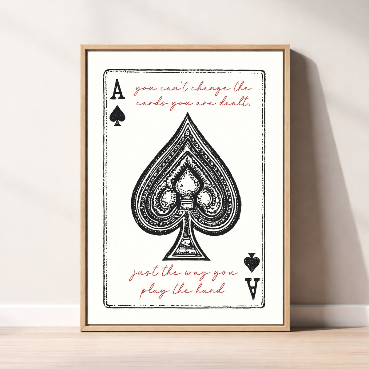 The image is a framed print featuring a spade playing card with the text "You can't change the cards you are dealt" and "Just the way you play the hand" written on it.