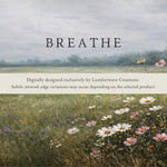 The image is a painting of a field with wildflowers, featuring a digital overlay that reads "BREATHE" in bold letters.