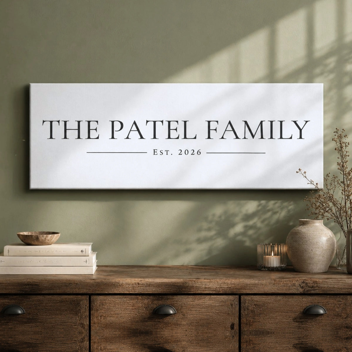 a wooden dresser with a white sign that reads "THE PATEL FAMILY EST. 2026" hanging on the wall above it.