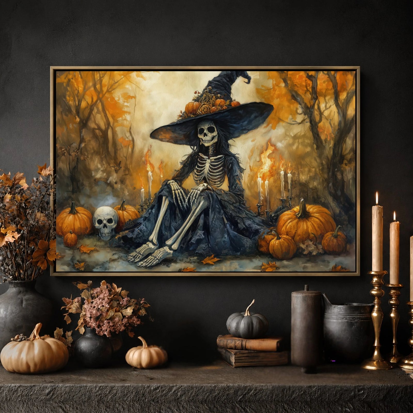 The image is a framed painting depicting a skeleton wearing a witch's hat, surrounded by pumpkins and other Halloween-themed decorations, set against a forest backdrop.