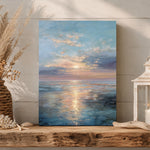 a serene painting of a sunset over the ocean, displayed on a wooden shelf.