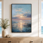 a large framed painting of a serene ocean scene with a sunset over the water, hanging on a wall above a wooden cabinet.