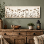 a wooden dresser with a framed wall art that says "Grow through what you go through". The dresser has a bowl, a candle, and a plant on it. There are also some decorative items on the dresser, such as a vase and a bottle.