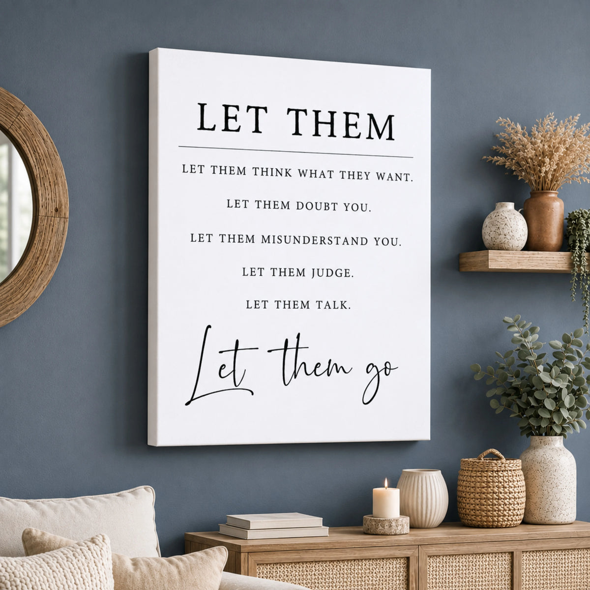a wall with a white canvas that displays a motivational quote in black text, which reads "Let them think what they want, let them doubt you, let them misunderstand you, let them judge you, let them talk." The wall is decorated with various items such as a mirror, a shelf with vases, and some plants, creating a cozy and inviting atmosphere.